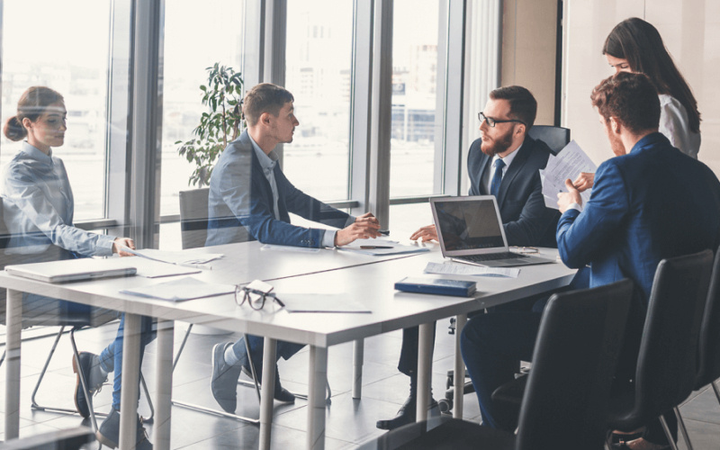 a group of people meeting in the office